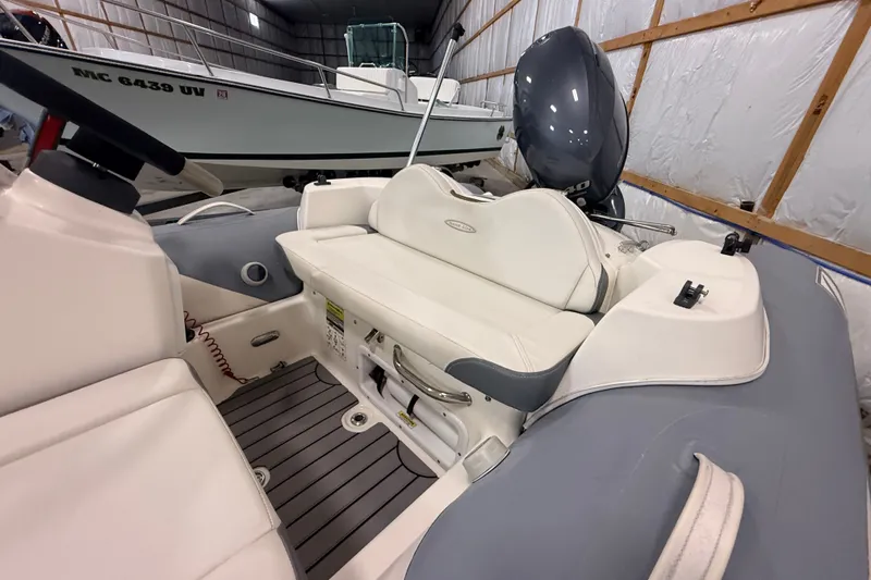 Slide: The Image of 2013 Zodiac Yachtline 2 Deluxe 340 inflatable boat interior with seating and motor. - 2