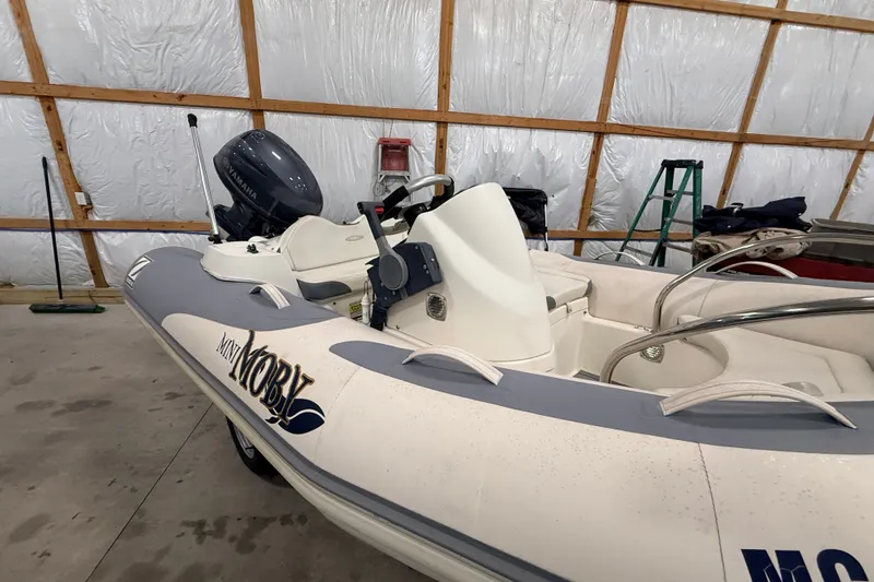 Slide: The Image of 2013 Zodiac Yachtline 2 Deluxe 340 inflatable boat in a storage facility. - 13