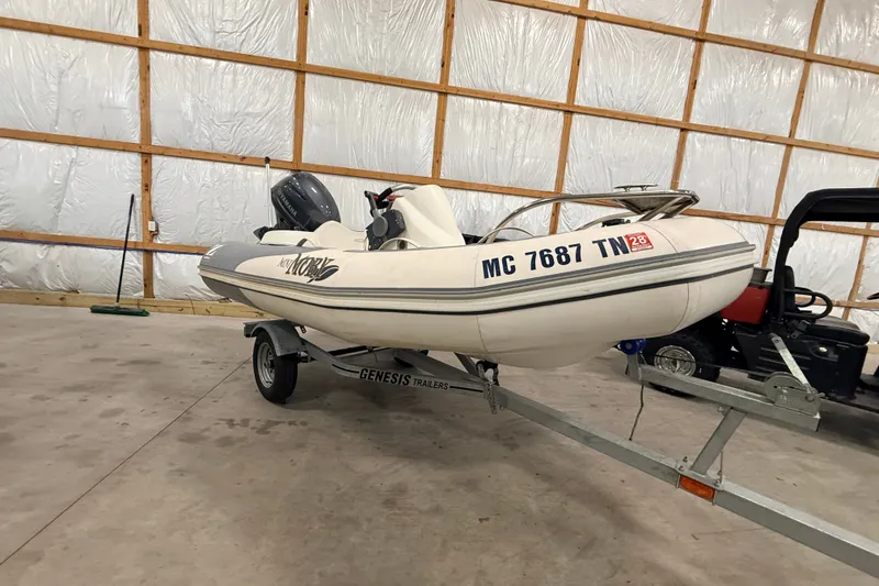 Slide: The Image of 2013 Zodiac Yachtline 2 Deluxe 340 boat on trailer in a garage. - 1