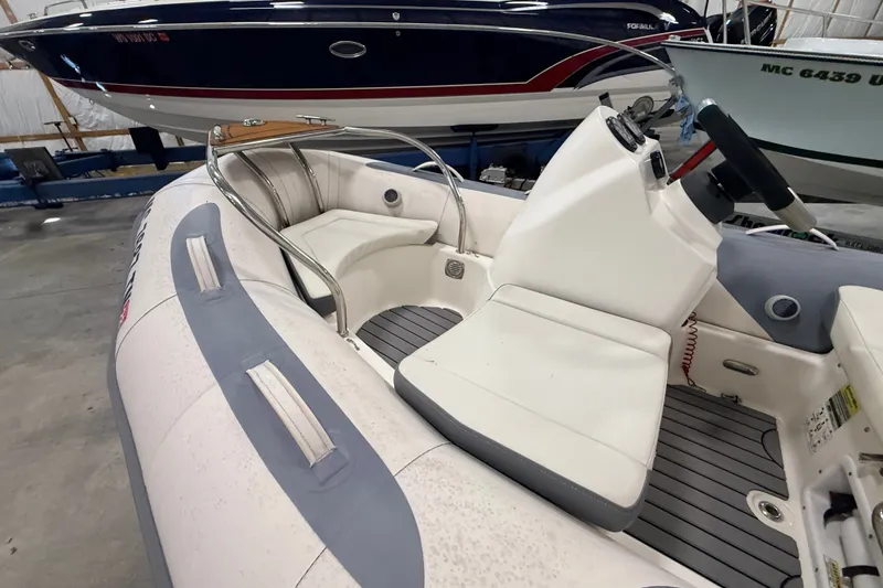 Slide: The Image of 2013 Zodiac Yachtline 2 Deluxe 340 inflatable boat interior with seating and steering console. - 3