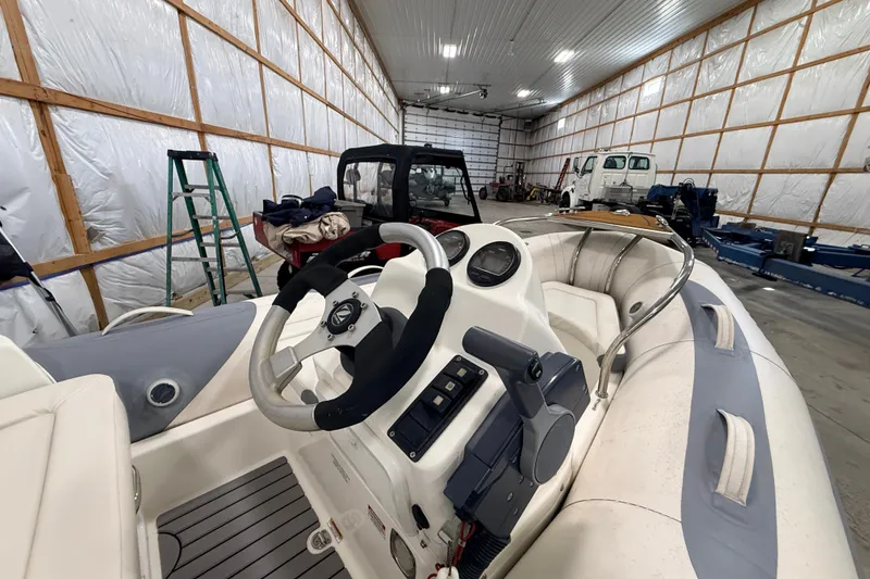 Slide: The Image of 2013 Zodiac Yachtline 2 Deluxe 340 boat interior in a spacious storage facility. - 12