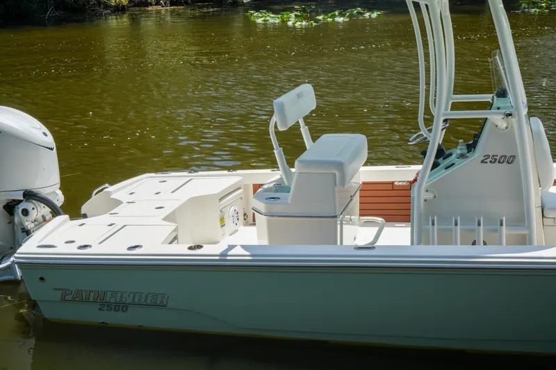 Slide: The Image of 2026 Pathfinder 2500 Tournament boat on calm water, showcasing sleek design and seating. - 11