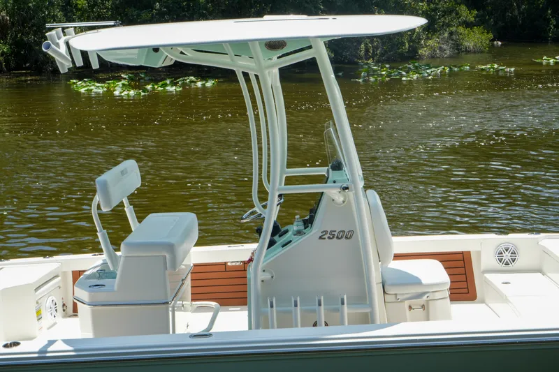 Slide: The Image of 2026 Pathfinder 2500 Tournament boat on a calm river with lush greenery. - 8