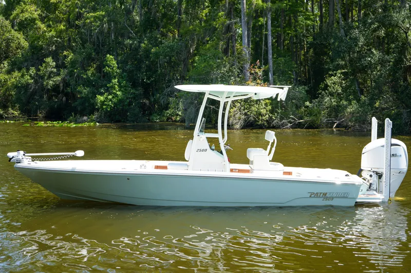 Slide: The Image of 2026 Pathfinder 2500 Tournament boat on a calm river, surrounded by lush greenery. - 37