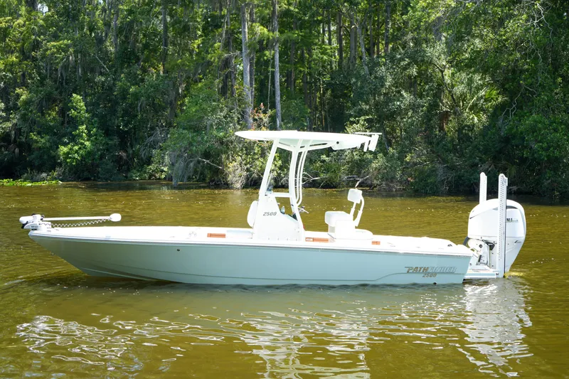 Slide: The Image of 2026 Pathfinder 2500 Tournament boat on a calm river, surrounded by lush greenery. - 31