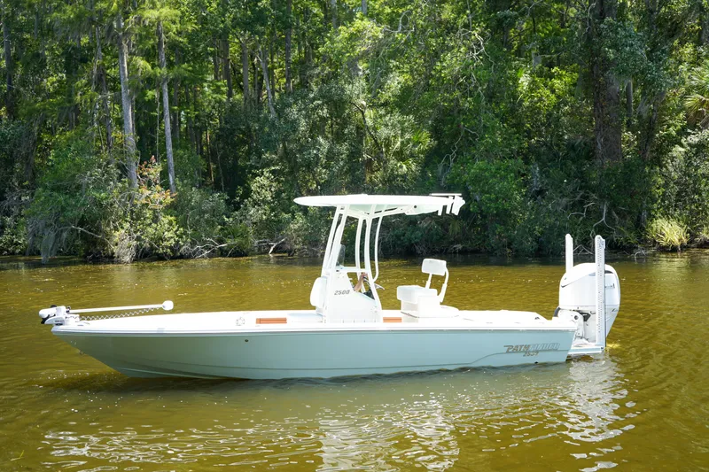 Slide: The Image of 2026 Pathfinder 2500 Tournament boat on calm river with lush forest backdrop. - 29