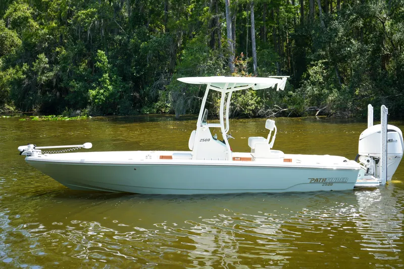 Slide: The Image of 2026 Pathfinder 2500 Tournament boat on a calm river, surrounded by lush greenery. - 35