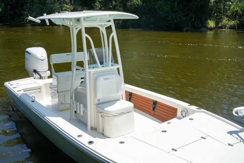 Slide: The Image of 2026 Pathfinder 2500 Tournament boat on calm river water, featuring sleek design and modern amenities. - 4