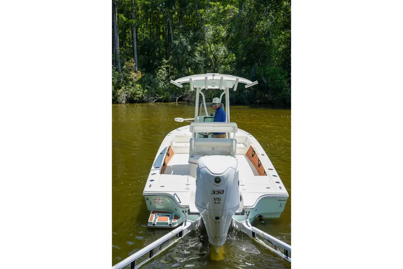 Slide: The Image of 2026 Pathfinder 2500 Tournament boat on a calm river, surrounded by lush greenery. - 26