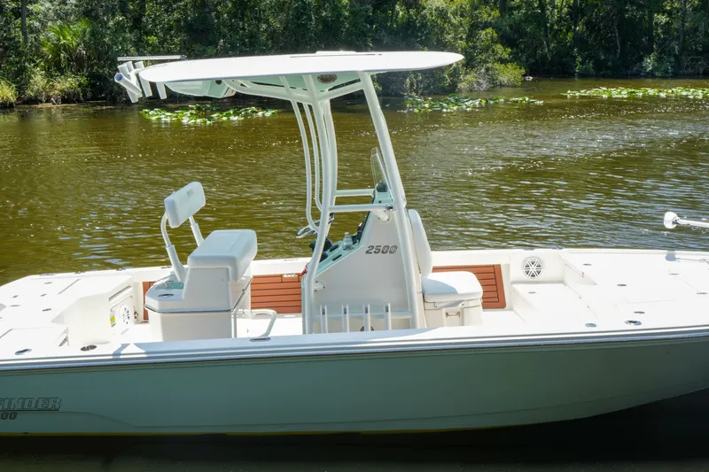 Slide: The Image of 2026 Pathfinder 2500 Tournament boat on a calm river with lush greenery. - 7