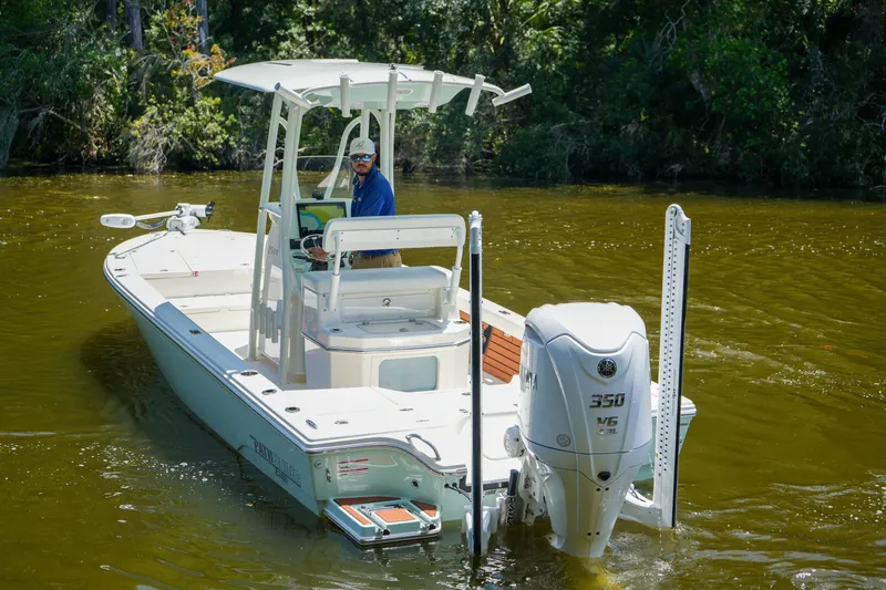 Slide: The Image of 2026 Pathfinder 2500 Tournament boat on calm water, featuring a powerful outboard motor. - 18