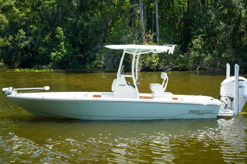 Slide: The Image of 2026 Pathfinder 2500 Tournament boat on a calm river, surrounded by lush greenery. - 36