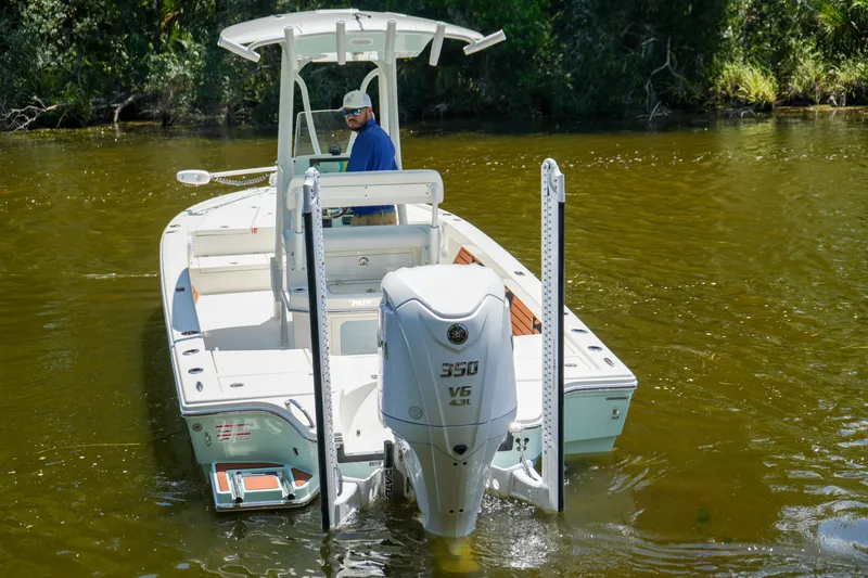 Slide: The Image of 2026 Pathfinder 2500 Tournament boat with powerful 350 V6 engine on a calm river. - 24