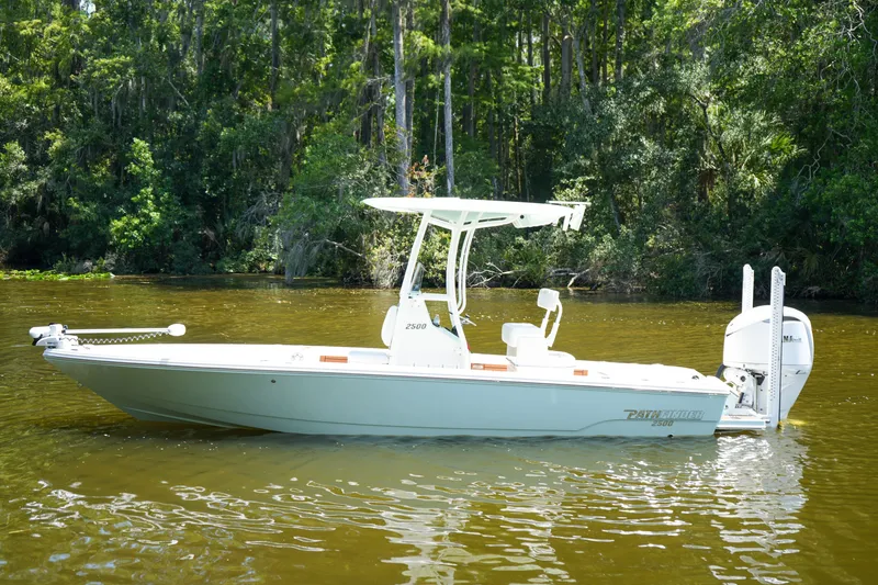 Slide: The Image of 2026 Pathfinder 2500 Tournament boat on a calm river, surrounded by lush greenery. - 33