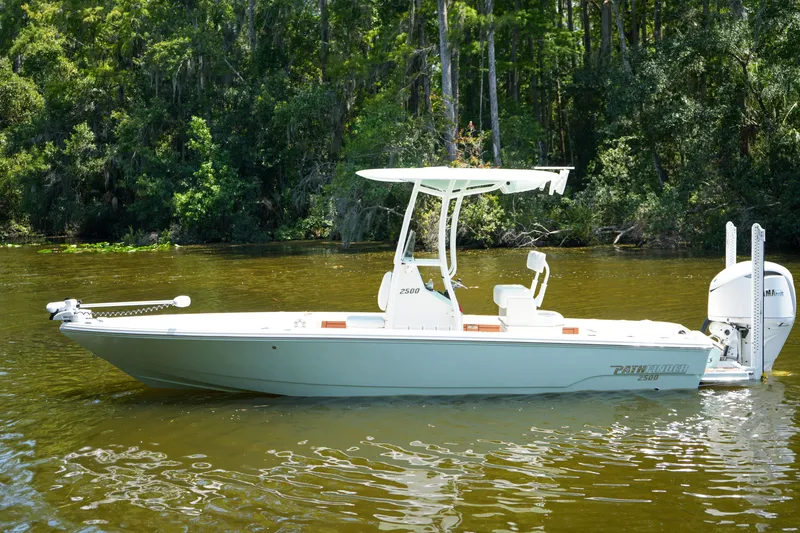 Slide: The Image of 2026 Pathfinder 2500 Tournament boat on a serene river, surrounded by lush greenery. - 34