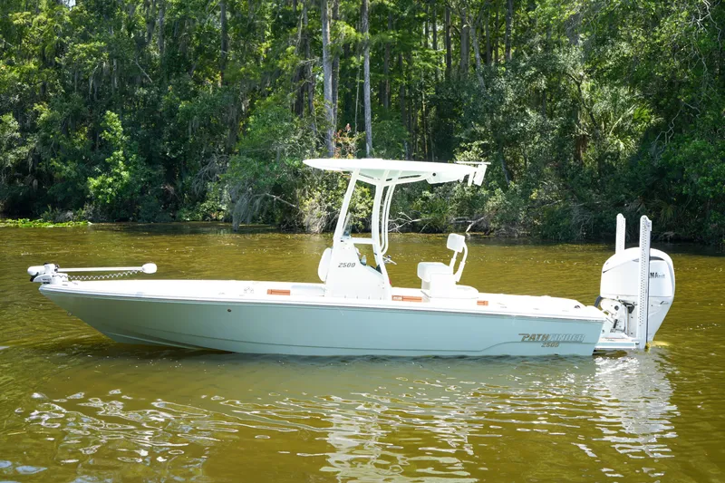 Slide: The Image of 2026 Pathfinder 2500 Tournament boat on a calm river, surrounded by lush greenery. - 32