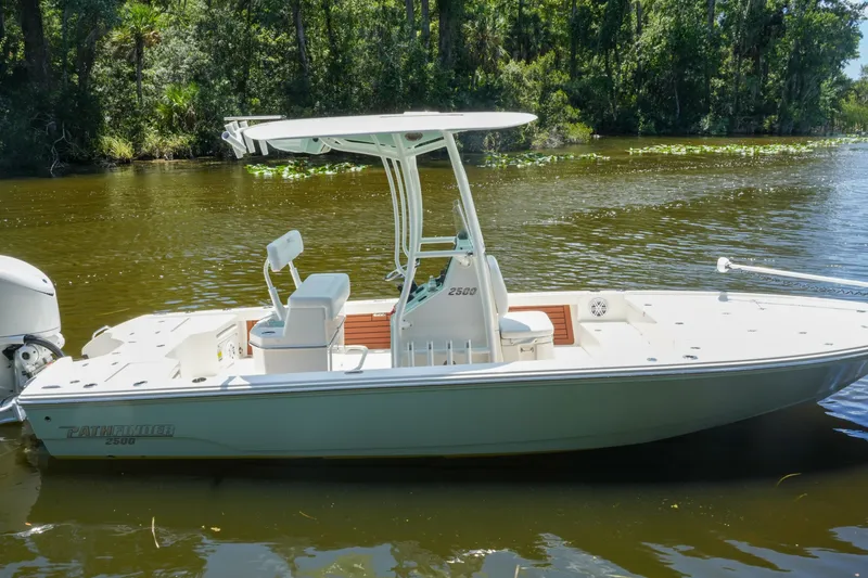 Slide: The Image of 2026 Pathfinder 2500 Tournament boat on a serene river, surrounded by lush greenery. - 6