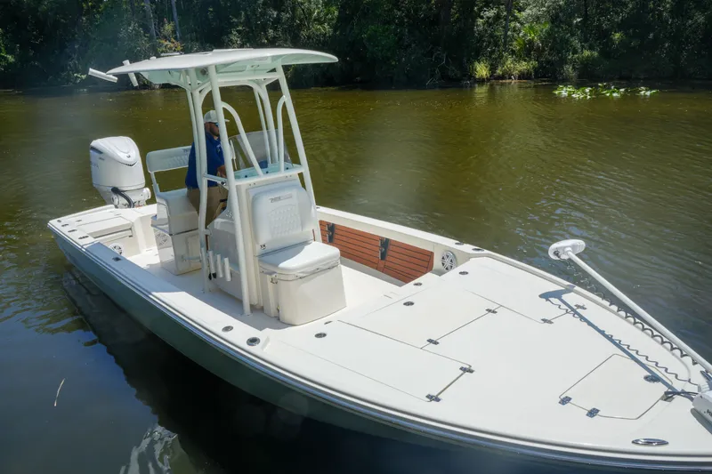 Slide: The Image of 2026 Pathfinder 2500 Tournament boat on a calm river, featuring a sleek design and modern amenities. - 2