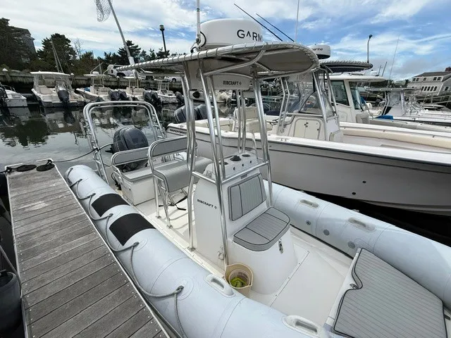 Slide: The Image of A 2022 Ribcraft 6.5 is docked. It features a sturdy design and modern equipment. - 3