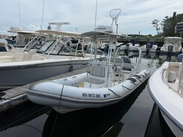 The Image of A 2022 Ribcraft 6.5 is docked. It features a sturdy design with a T-top. - 0