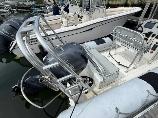 Slide: The Image of A 2022 Ribcraft 6.5 with Yamaha outboard engines, docked in a marina. - 4