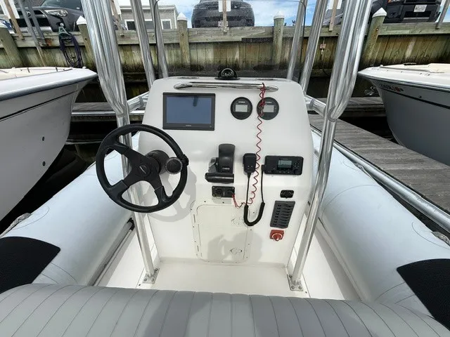 Slide: The Image of The image shows the cockpit of a 2022 Ribcraft 6.5 with steering wheel, instruments, and seating. - 6