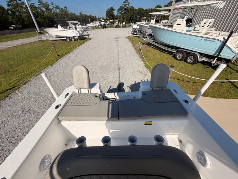 Slide: The Image of The image shows the stern of a Savannah SS21 boat with seating and fishing rod holders. - 13