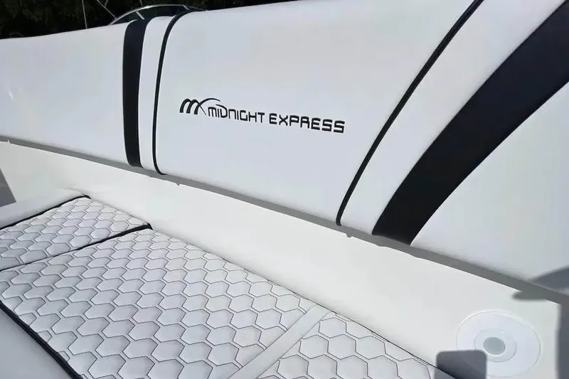 Slide: The Image of 2009 Midnight Express 34 Open boat interior with sleek white seating and logo. - 18