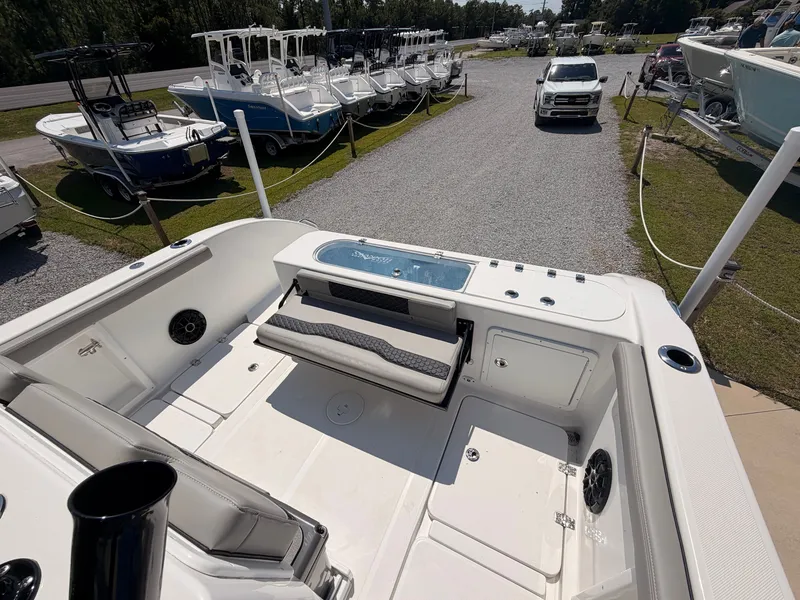 Slide: The Image of The image shows the deck of a 2027 Savannah 2900 Offshore boat, parked in a boatyard. - 17