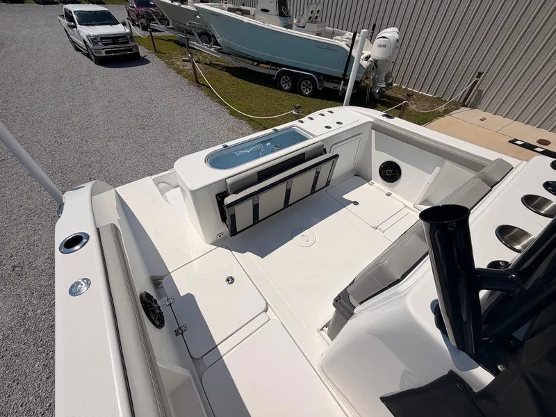 Slide: The Image of The image shows the deck of a 2027 Savannah 2900 Offshore boat, featuring seating and storage. - 15