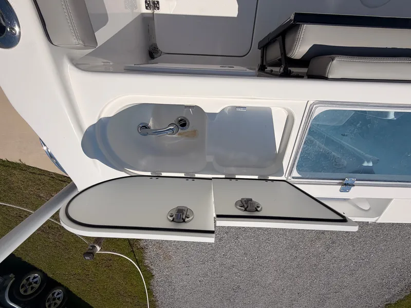 Slide: The Image of The image shows part of the 2027 Savannah 2900 Offshore boat. Visible is an open storage compartment with a sink and faucet. - 19