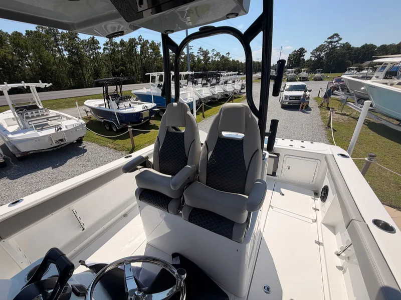 Slide: The Image of The image shows the cockpit of a 2027 Savannah 2900 Offshore boat with two cushioned seats. - 14