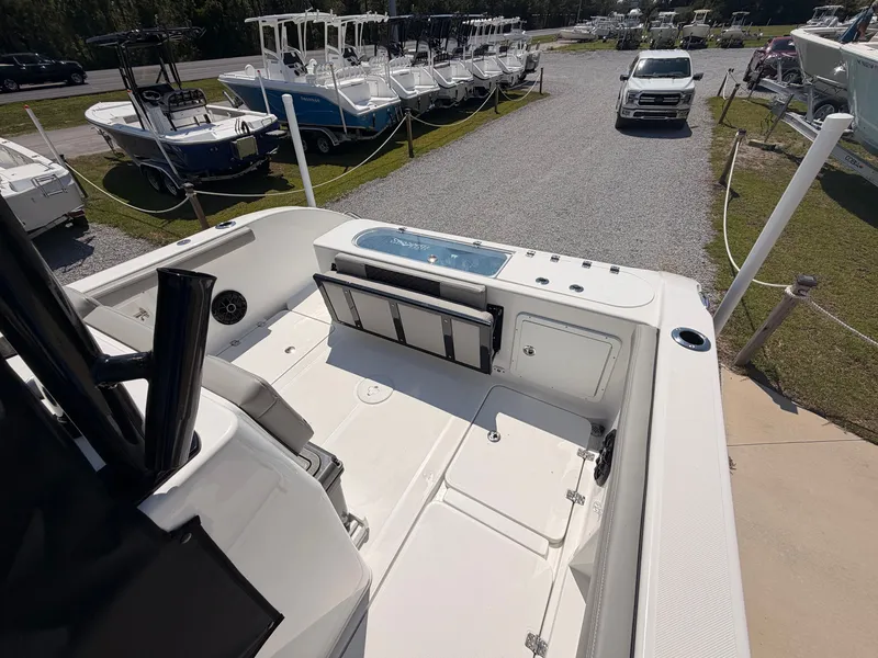 Slide: The Image of The image shows the spacious deck of a 2027 Savannah 2900 Offshore boat, parked at a boatyard. - 16