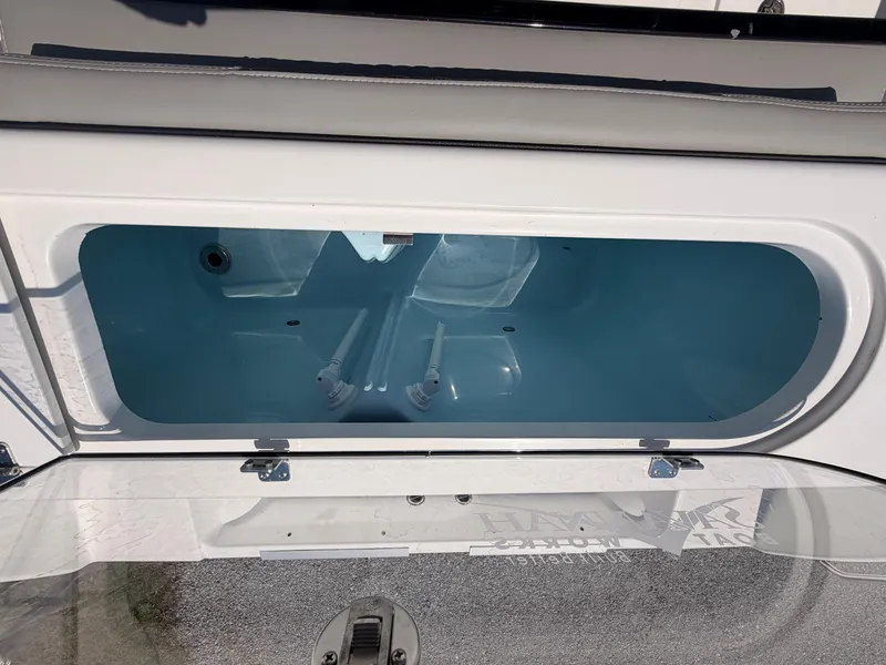 Slide: The Image of An open storage compartment on a 2027 Savannah 2900 Offshore boat, featuring a blue interior. - 18
