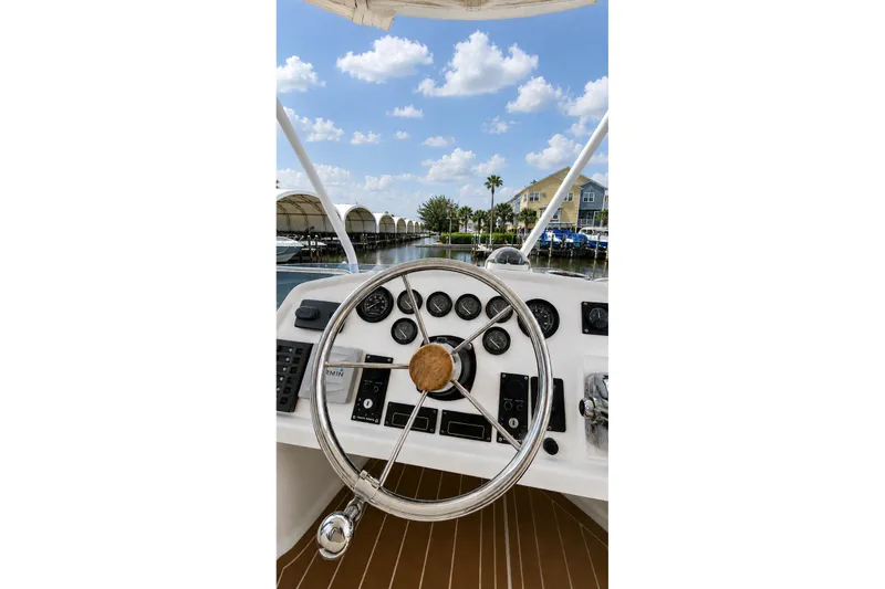 Slide: The Image of Steering wheel of 2006 Fountaine Pajot Highland 35 Pilot boat, docked under blue sky. - 14