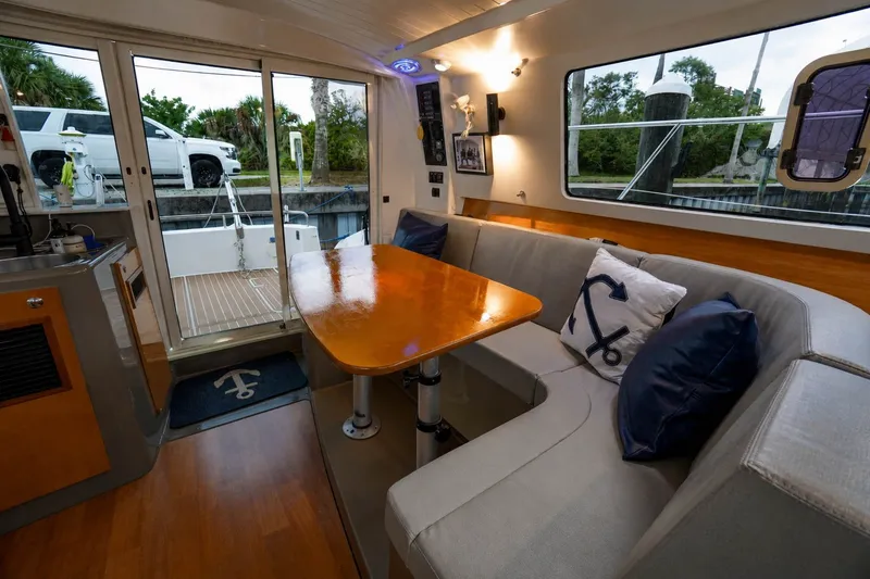 Slide: The Image of Interior of 2006 Fountaine Pajot Highland 35 Pilot with cozy seating and nautical decor. - 20