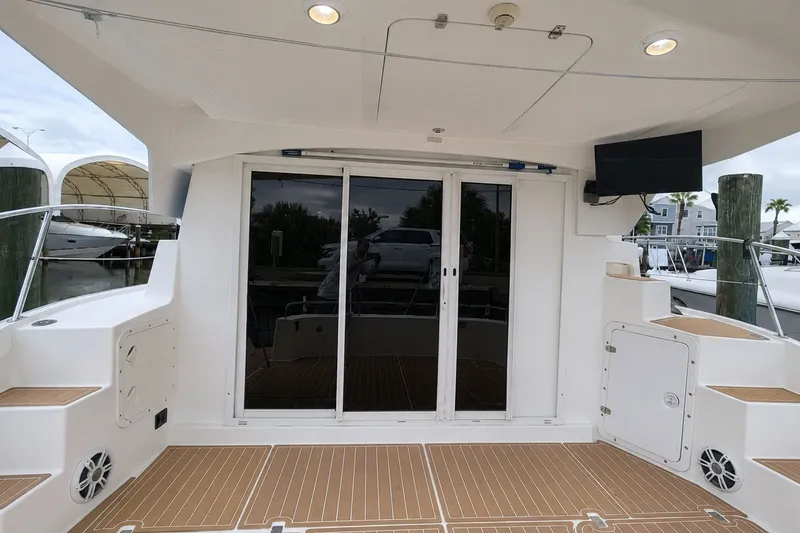 Slide: The Image of 2006 Fountaine Pajot Highland 35 Pilot yacht deck with sliding glass doors and outdoor seating. - 6