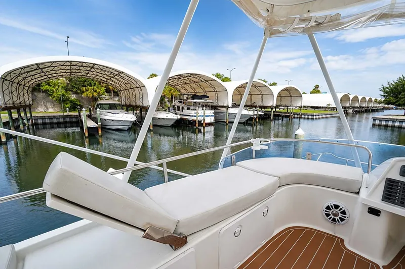 Slide: The Image of 2006 Fountaine Pajot Highland 35 Pilot yacht docked at marina with covered slips. - 17