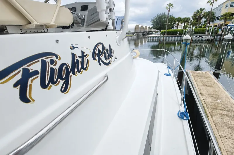 Slide: The Image of 2006 Fountaine Pajot Highland 35 Pilot boat docked, featuring "Flight Risk" name. - 12