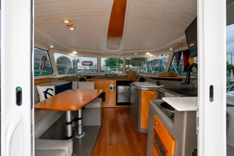 Slide: The Image of Interior of 2006 Fountaine Pajot Highland 35 Pilot yacht, featuring modern kitchen and dining area. - 18