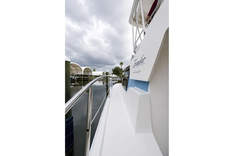 Slide: The Image of Side view of 2006 Fountaine Pajot Highland 35 Pilot yacht docked under cloudy skies. - 7