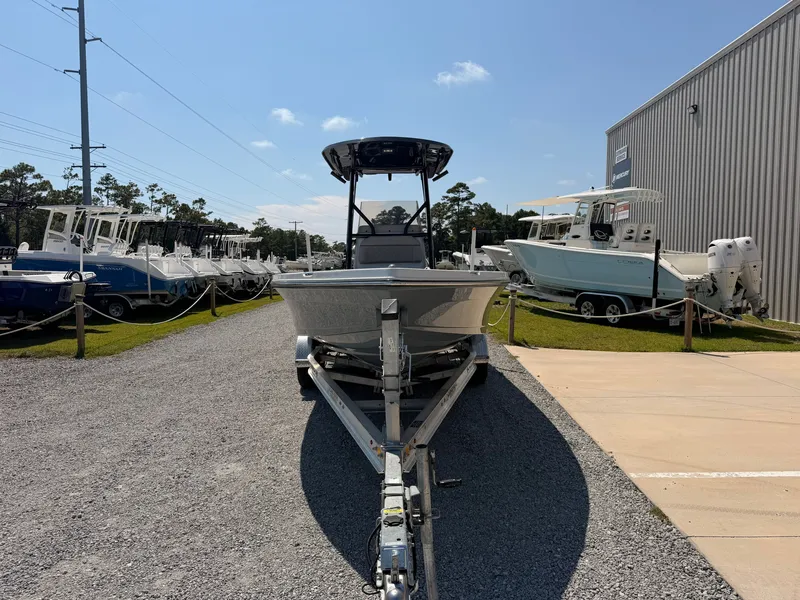 Slide: The Image of A 2027 Savannah 220 IS boat on a trailer in an outdoor showroom setting. - 6