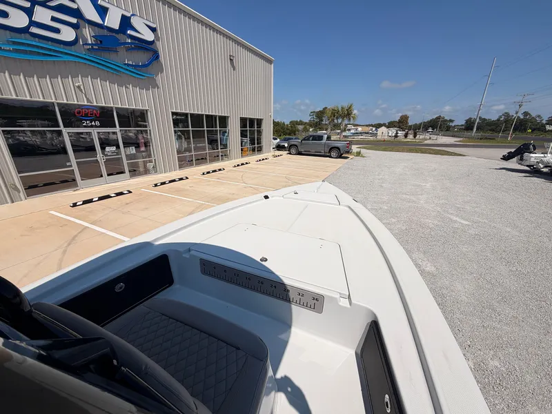 Slide: The Image of A 2027 Savannah 220 IS boat is parked outside a boat dealership on a lot. - 9