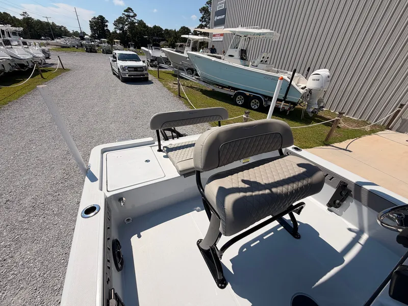 Slide: The Image of The image shows the cockpit of a 2027 Savannah 220 IS boat with cushioned seats. - 12