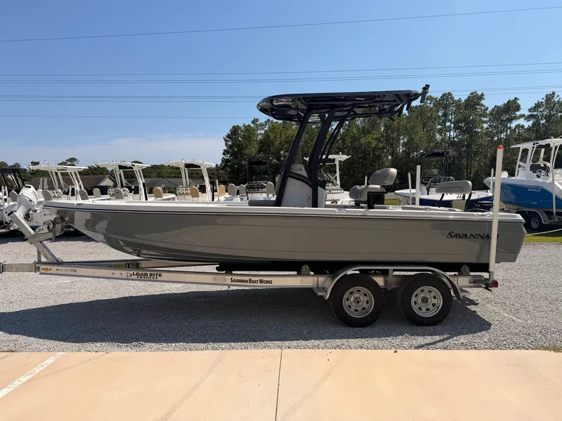 Slide: The Image of 2027 Savannah 220 IS boat on a trailer, featuring a T-top and outboard motor. - 4