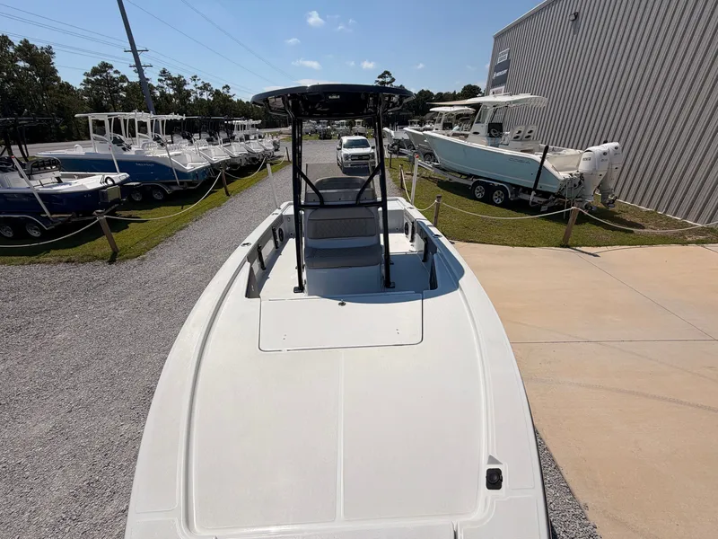 Slide: The Image of The image shows a 2027 Savannah 220 IS boat parked on a lot, with other boats in the background. - 10