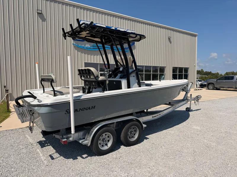 Slide: The Image of A gray 2027 Savannah 220 IS boat on a trailer in front of a building. - 1