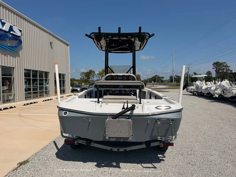 Slide: The Image of The image shows a gray boat, Savannah 220 IS model, on a gravel lot in front of a building. - 2