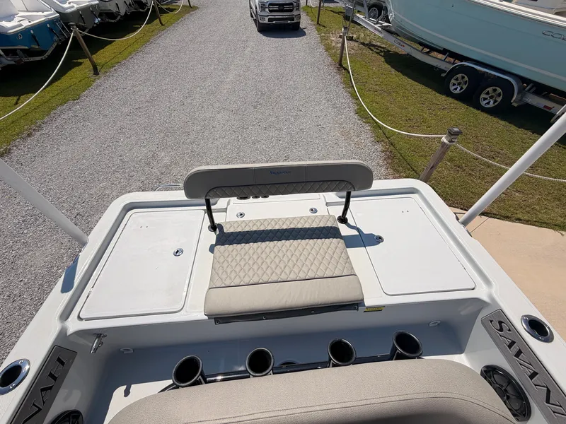 Slide: The Image of The image shows the stern of a Savannah 220 IS boat with a cushioned bench and cup holders. - 13