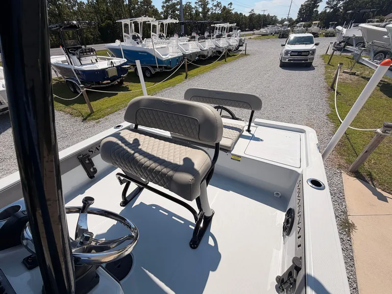 Slide: The Image of The image shows the deck of a 2027 Savannah 220 IS boat with two cushioned seats. - 11